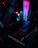 The image features the interior of a computer with a focus on a graphics card labeled 'GEFORCE RTX' and RGB lighting components. The lighting displays vibrant hues of pink, blue, and red, illuminating the surrounding hardware.