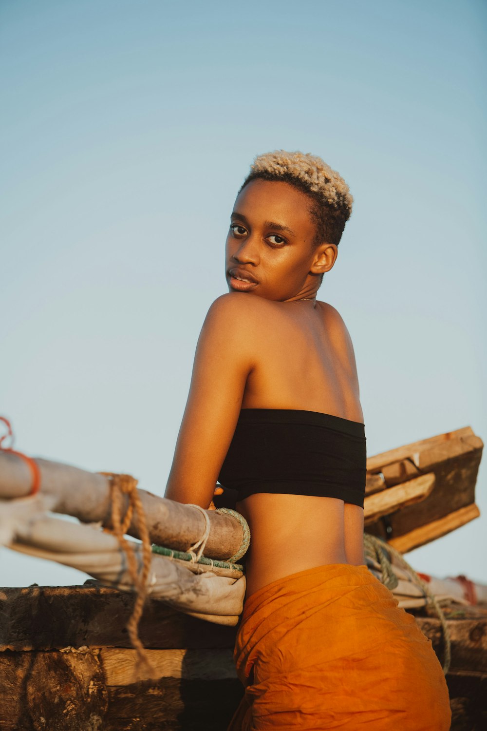 a woman sitting on top of a wooden boat