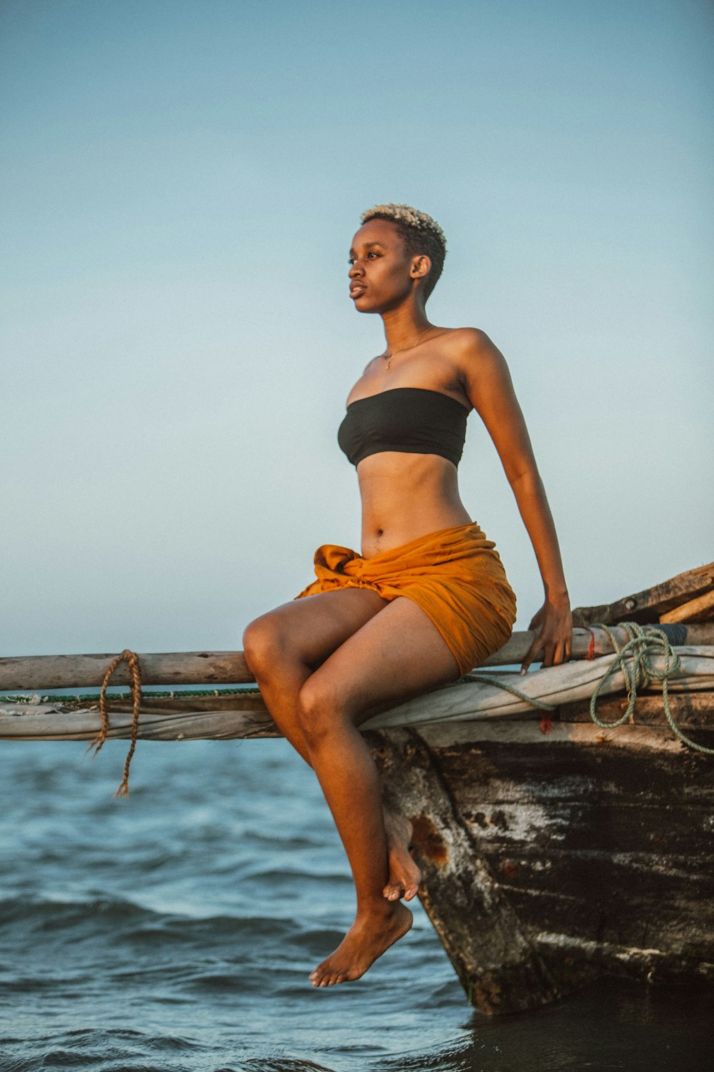 a woman is sitting on a boat in the water