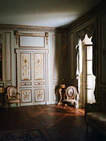 A lavish living room featuring a large Zarafshar carpet anchoring elegant, heritage-inspired decor.