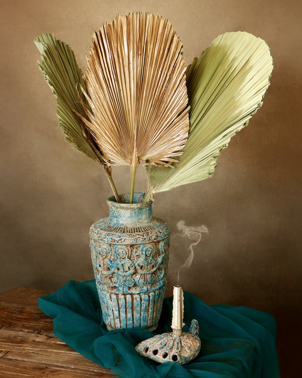 a vase with a plant in it sitting on a table