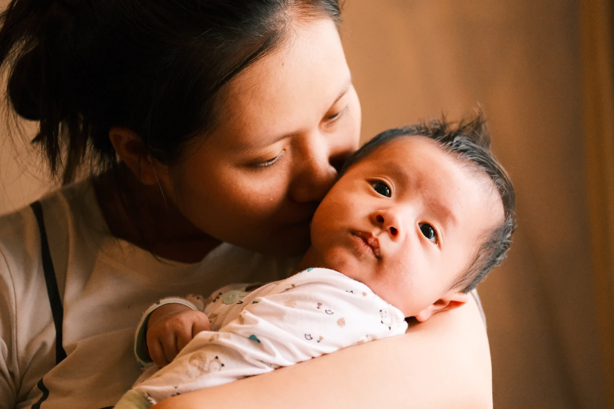 Mother holding her smiling baby close, making eye contact