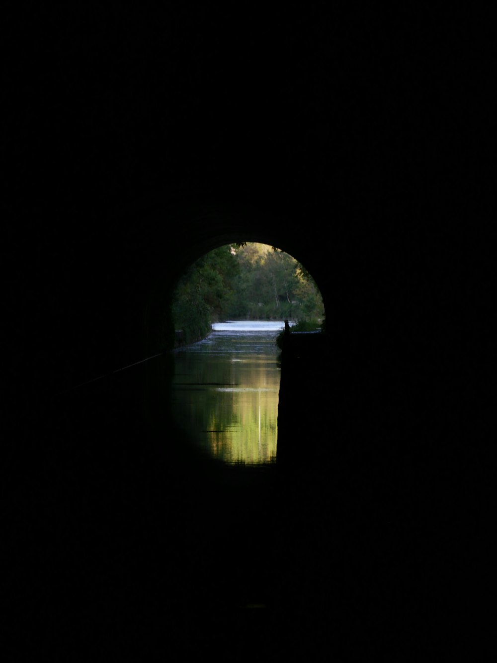 a man is fishing in the dark water