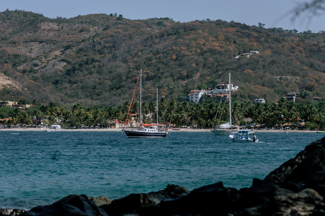a couple of boats floating on top of a body of water,
