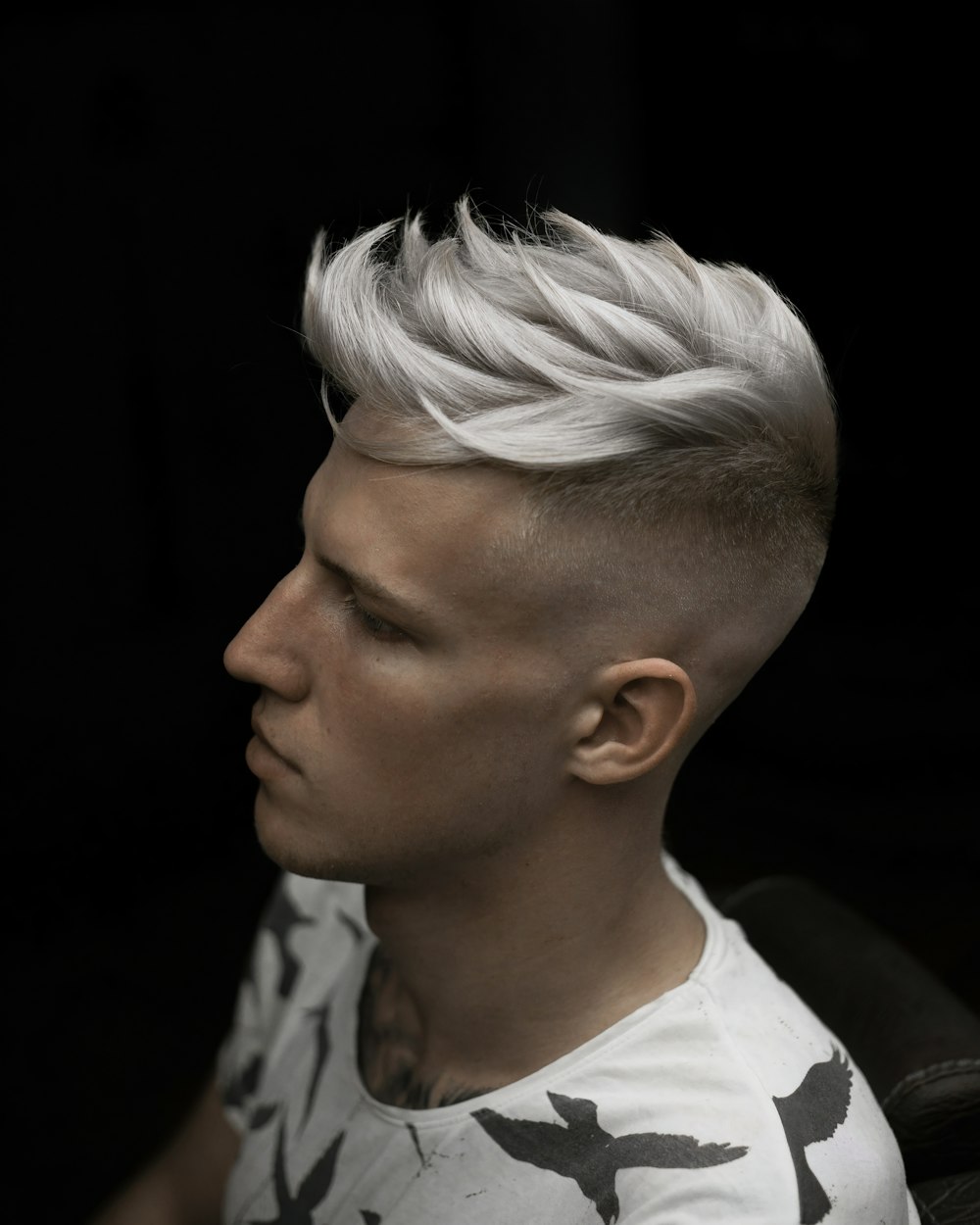 a man with white hair and a mohawk