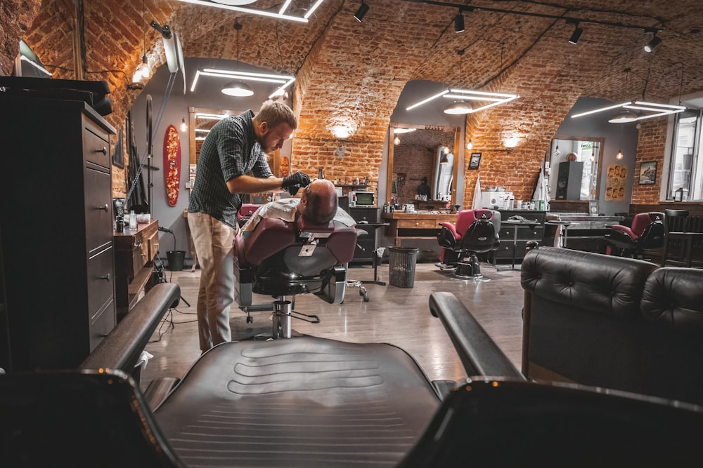 a man getting his hair cut in a barber shop