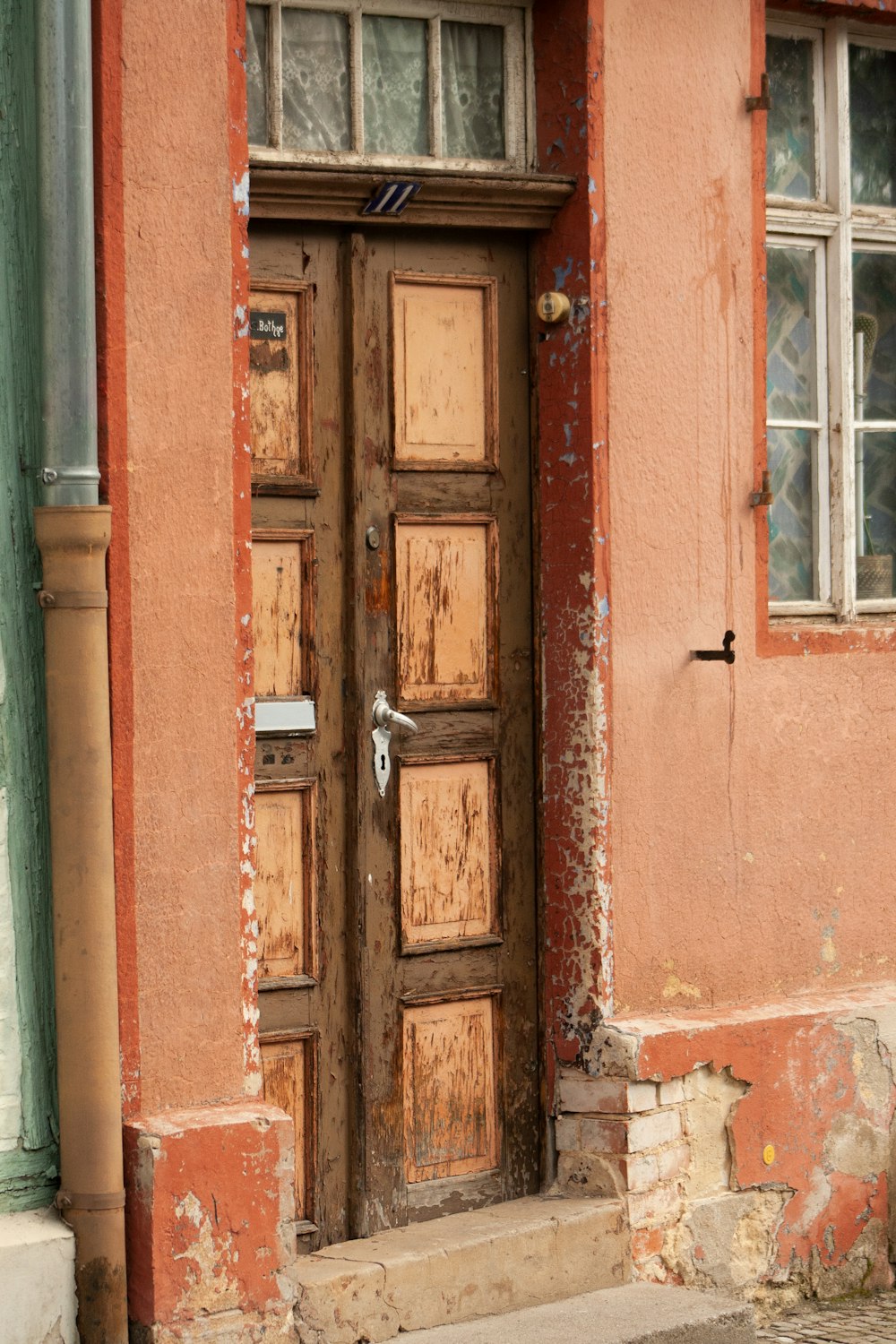 a red building with a wooden door and window