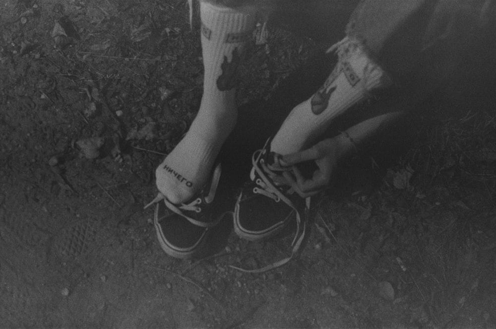 a black and white photo of a person's feet with socks on