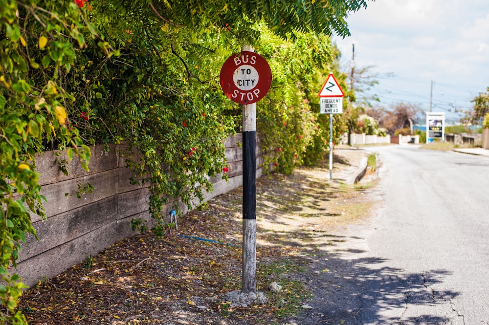a red street sign sitting on the side of a road