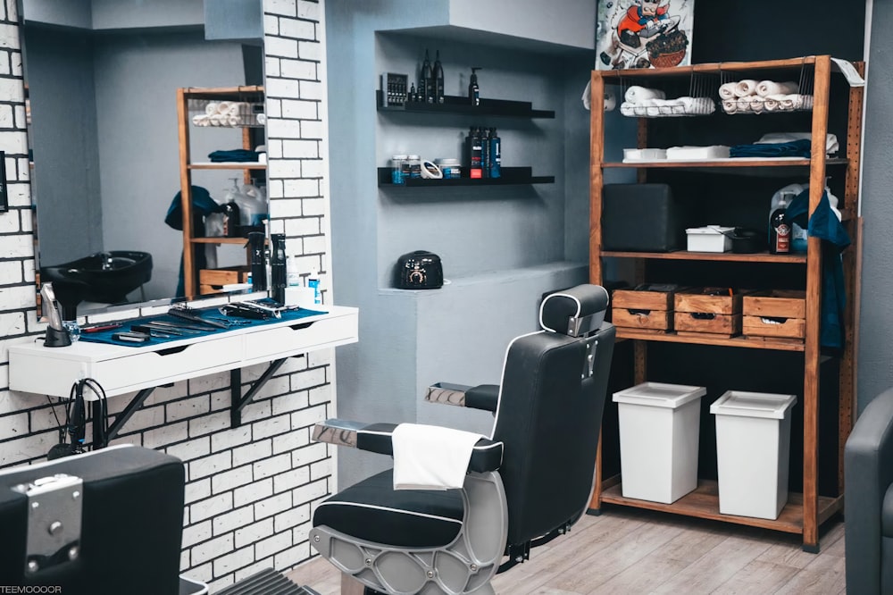 a room with a chair, shelves, and a hair dryer