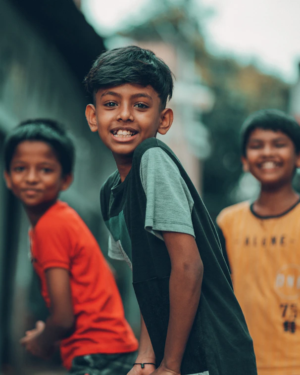 a group of young boys standing next to each other