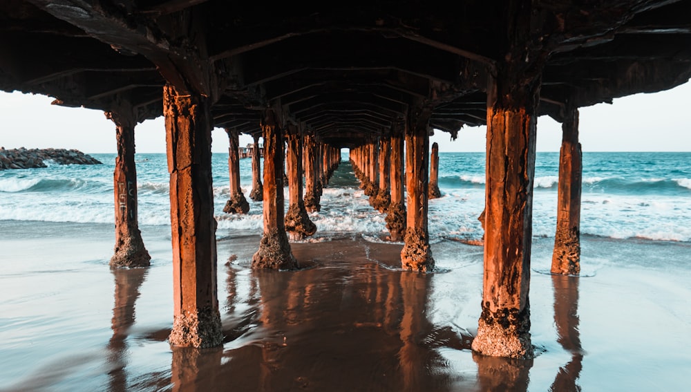 a view of the ocean under a pier