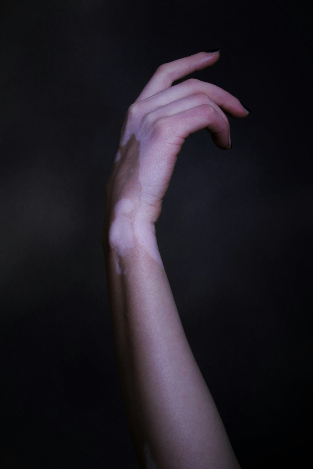 a woman's arm with a lot of white paint on it