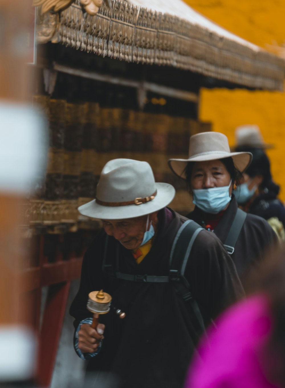 a group of people wearing hats and masks