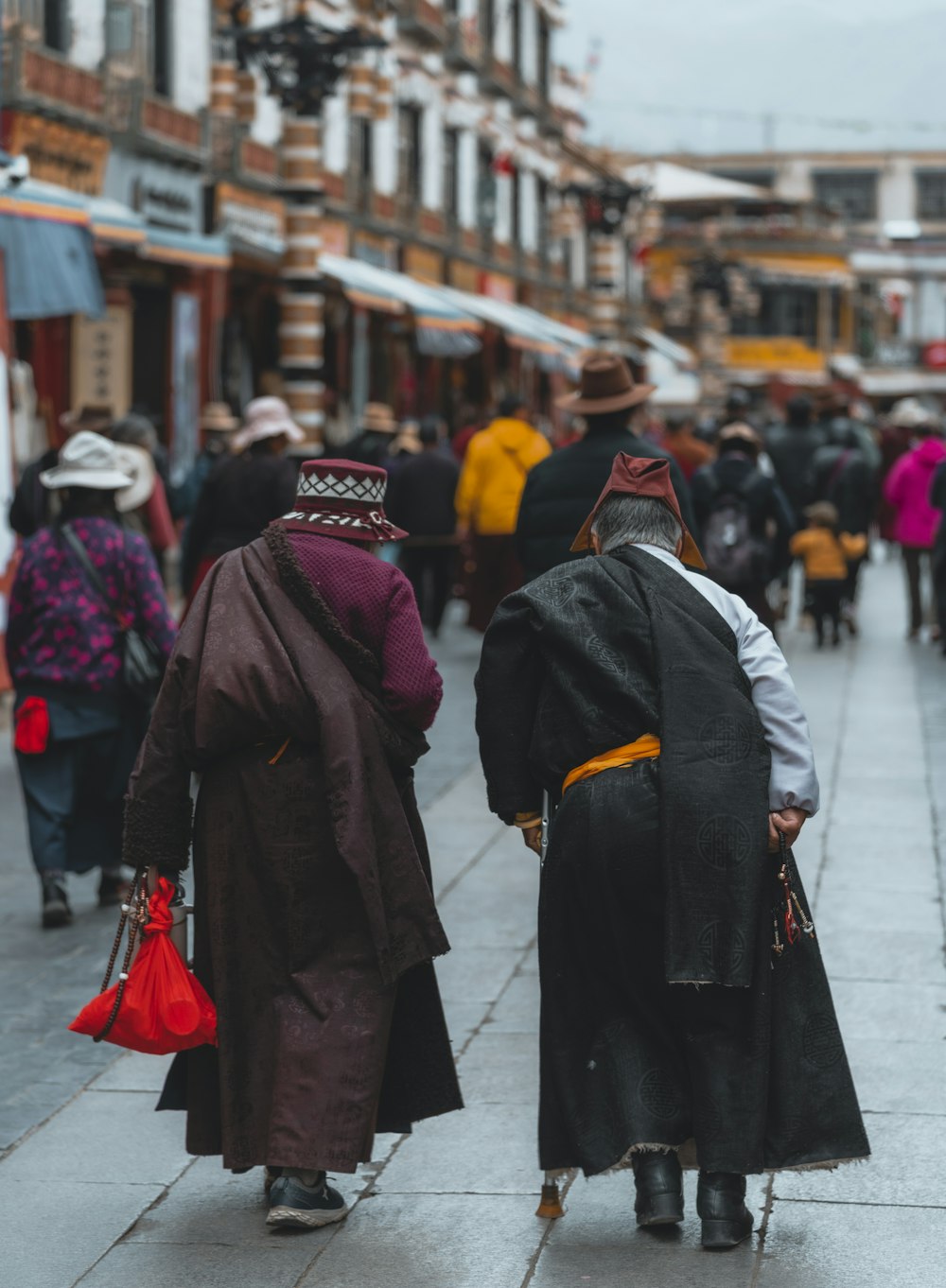 a couple of people walking down a street