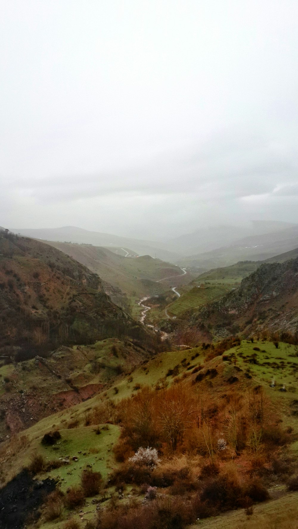 a view of a valley with a river running through it