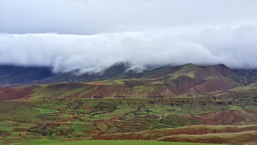 a view of a valley with mountains in the background