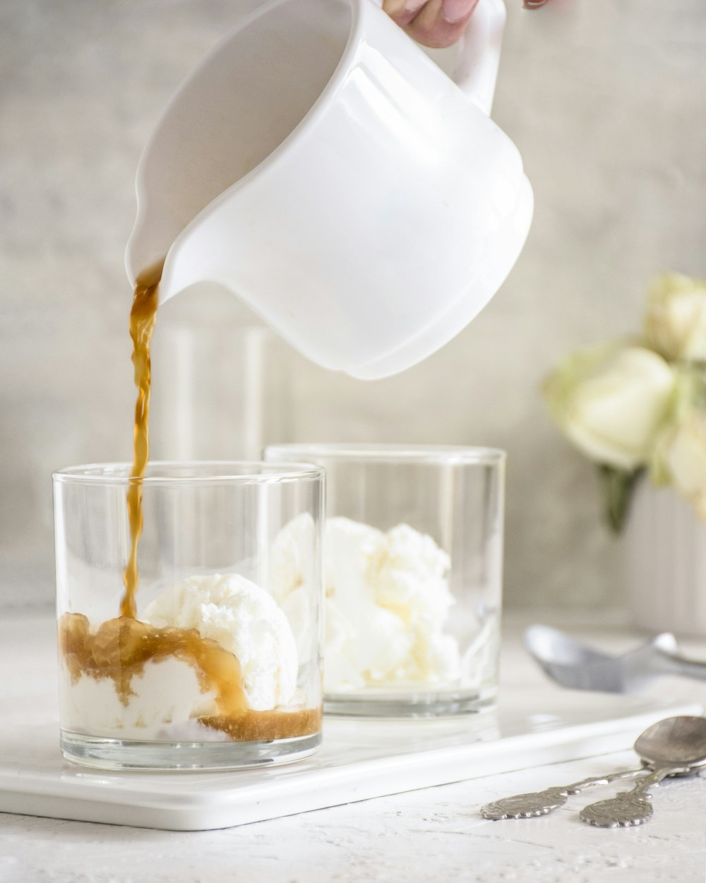 a person pouring ice cream into a glass