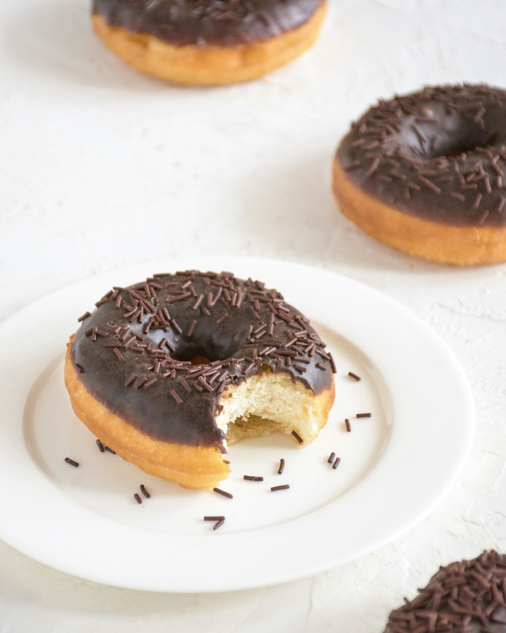 a chocolate covered doughnut with a bite taken out of it