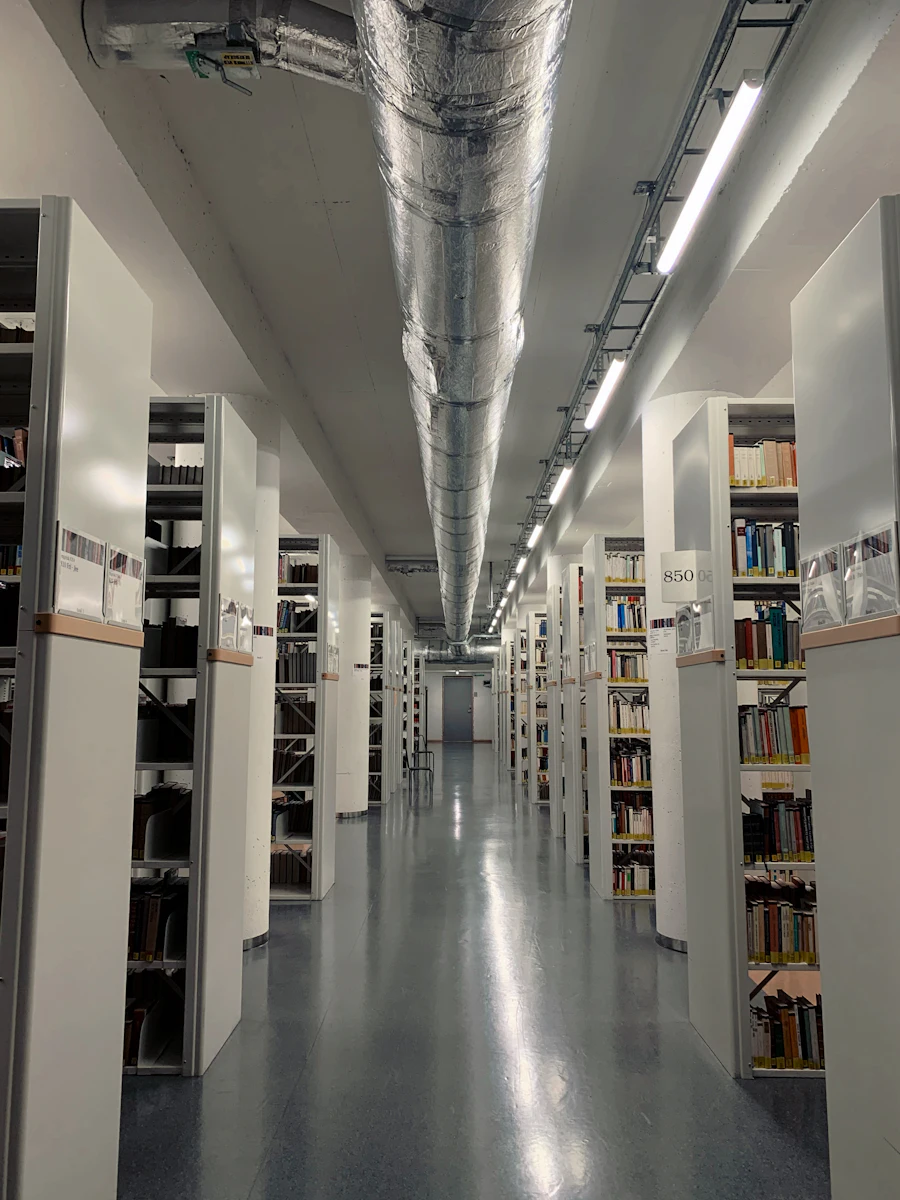 Long library reading room lined with bookshelves