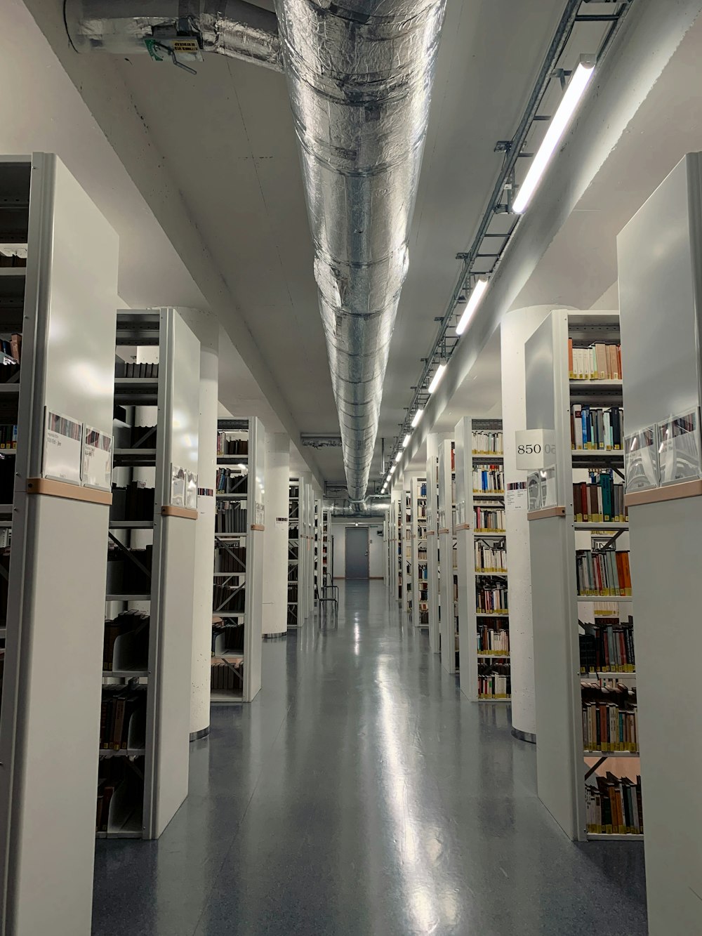 a long room with lots of books on shelves