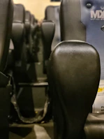 View of the cinema seats equipped with motion technology and viewers immersed in a horror film.