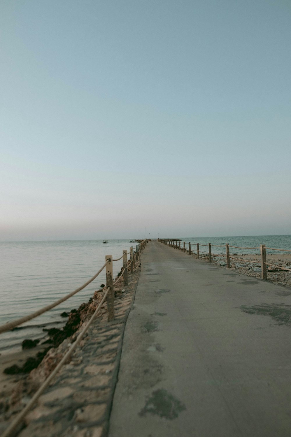 a long wooden walkway next to the ocean