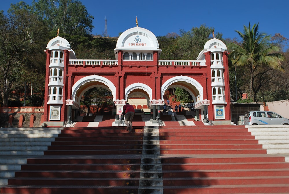 a large red building with white arches and arches