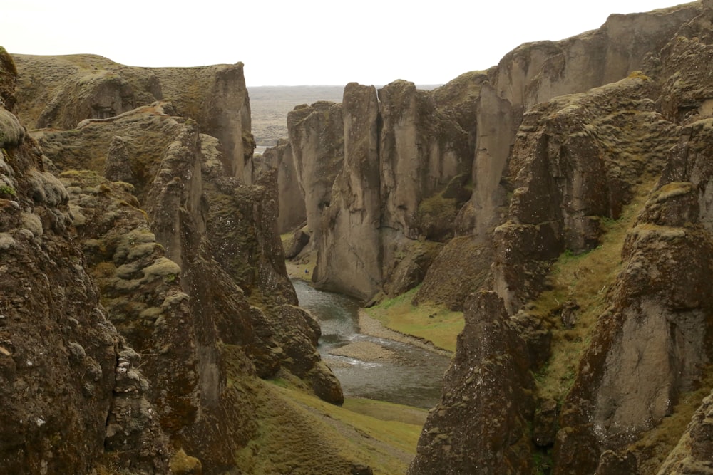 a rocky landscape with a river in the middle of it