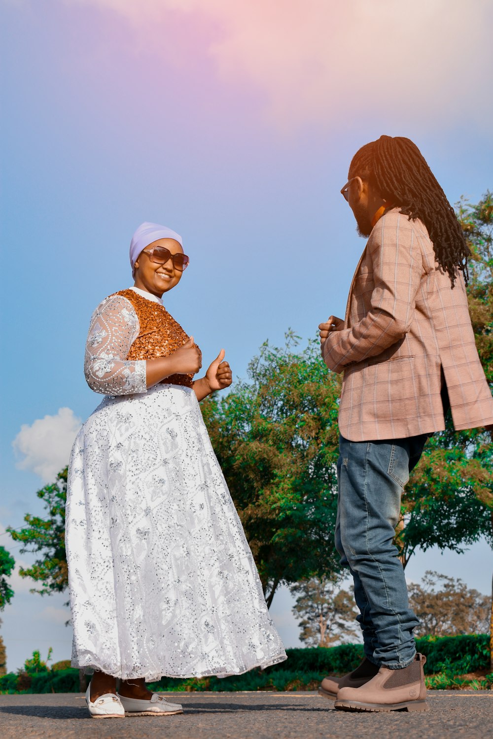 a woman in a white dress standing next to a man