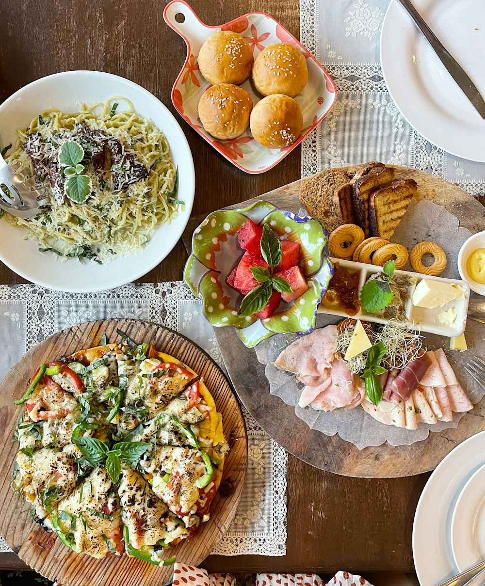 a table topped with plates and bowls of food