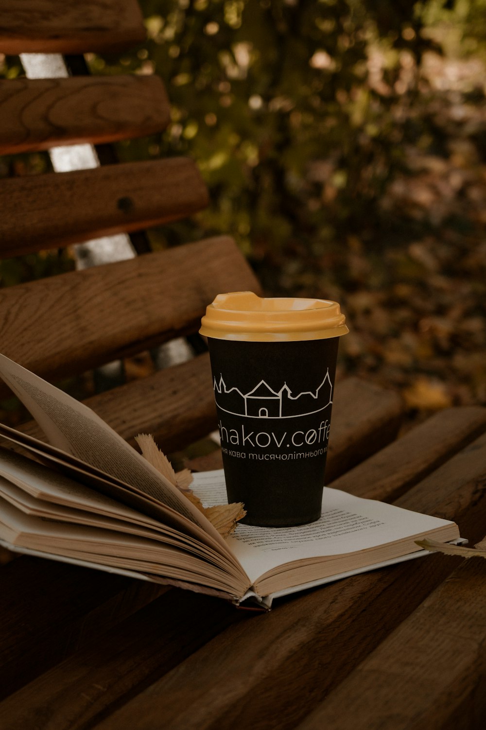 a cup of coffee sitting on top of a book