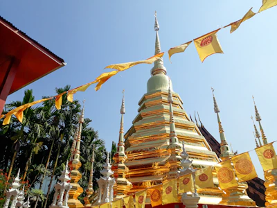 Morning aarti at the temple entrance with saffron flags fluttering under gentle sunlight.
