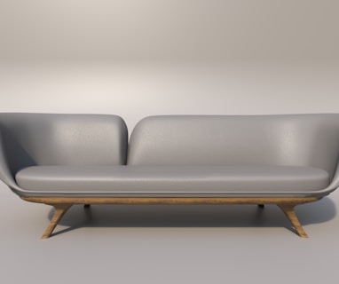 a gray couch with a wooden base on a gray background