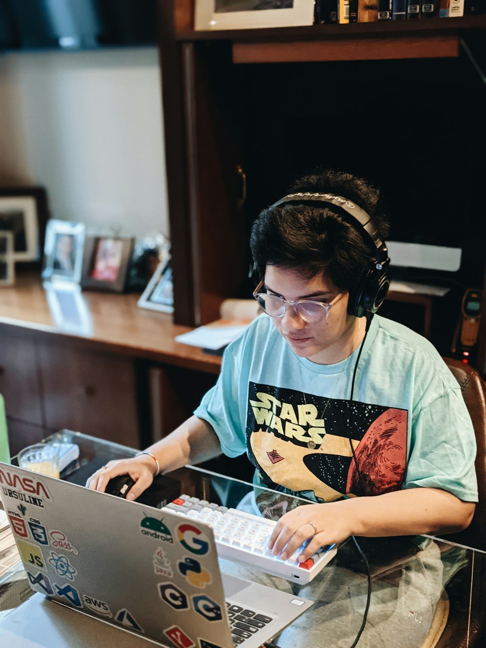 a person sitting at a desk with a laptop