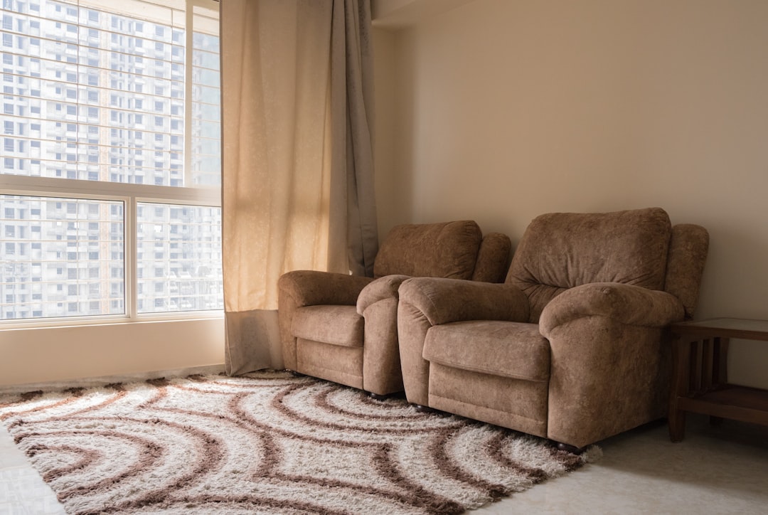 a living room with a chair and a rug