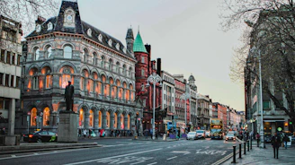 a city street with a clock tower in the middle of it