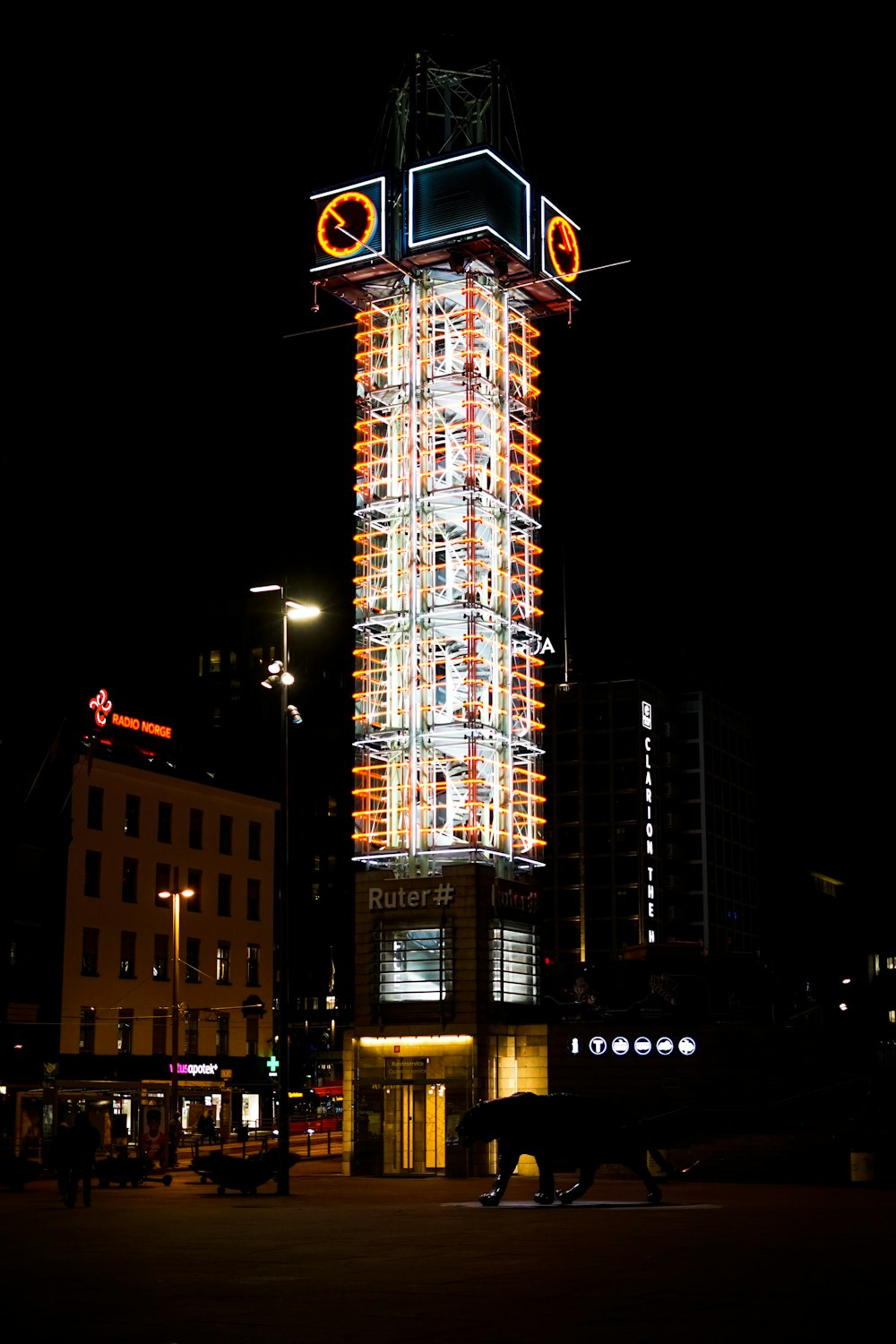 a tall clock tower sitting next to a tall building