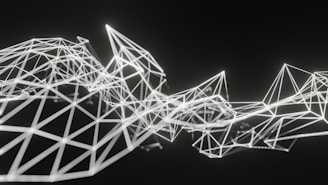Geometric structures composed of interconnected white lines form an abstract polygonal pattern on a dark background. The lines create various triangular and diamond shapes, giving a sense of three-dimensional depth and complexity.