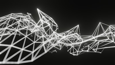 Geometric structures composed of interconnected white lines form an abstract polygonal pattern on a dark background. The lines create various triangular and diamond shapes, giving a sense of three-dimensional depth and complexity.