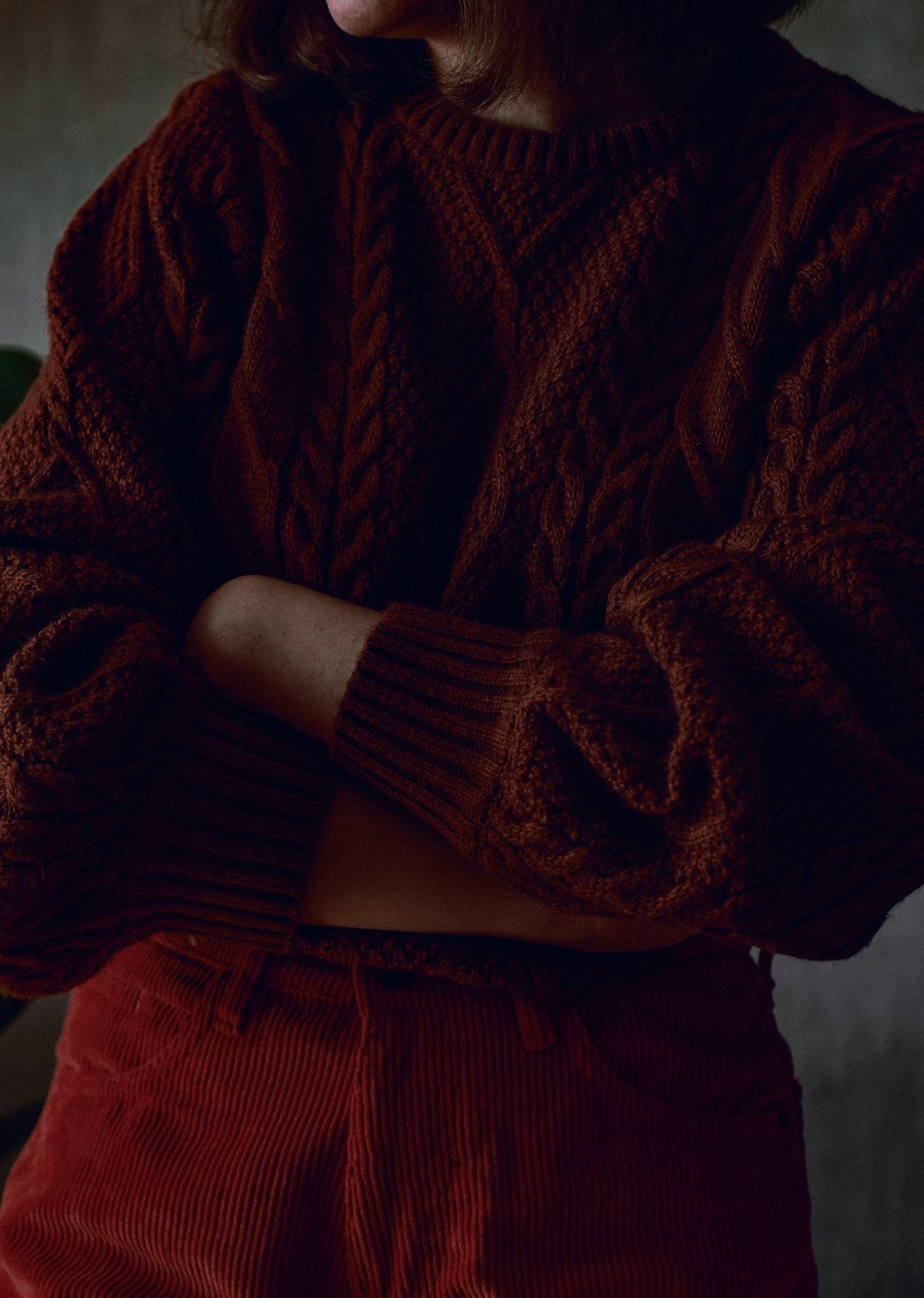 a woman wearing a red sweater and red pants