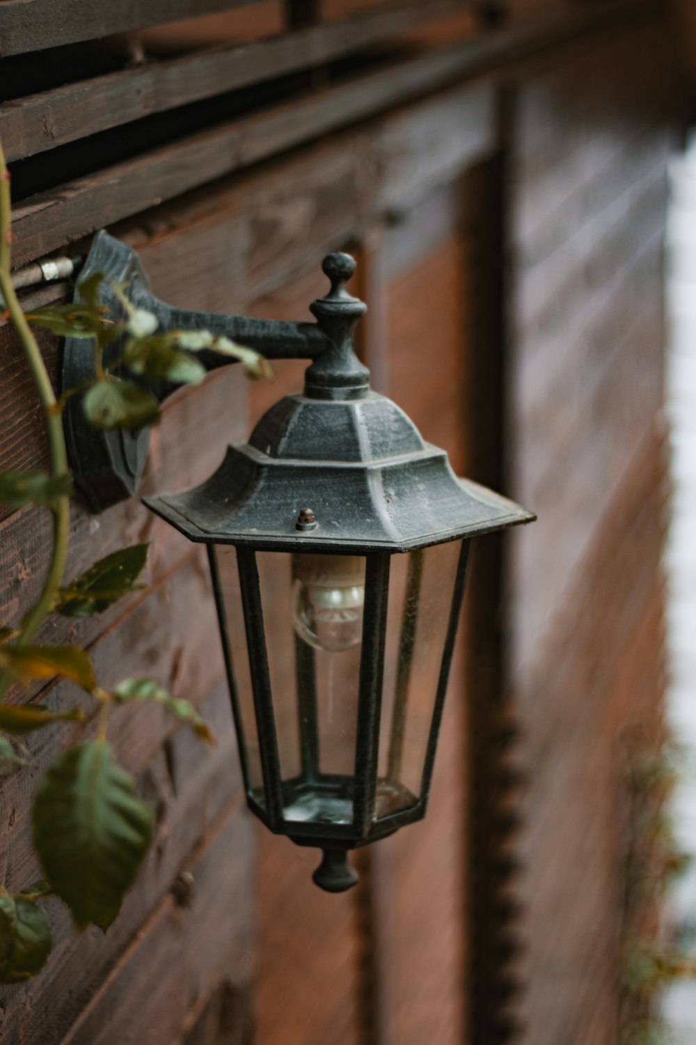 a lamp hanging on the side of a building