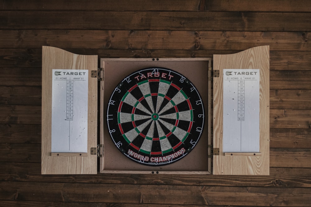a dart board mounted to a wooden wall