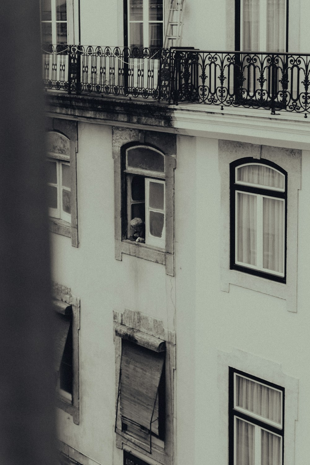 une photo en noir et blanc d’un immeuble avec balcon