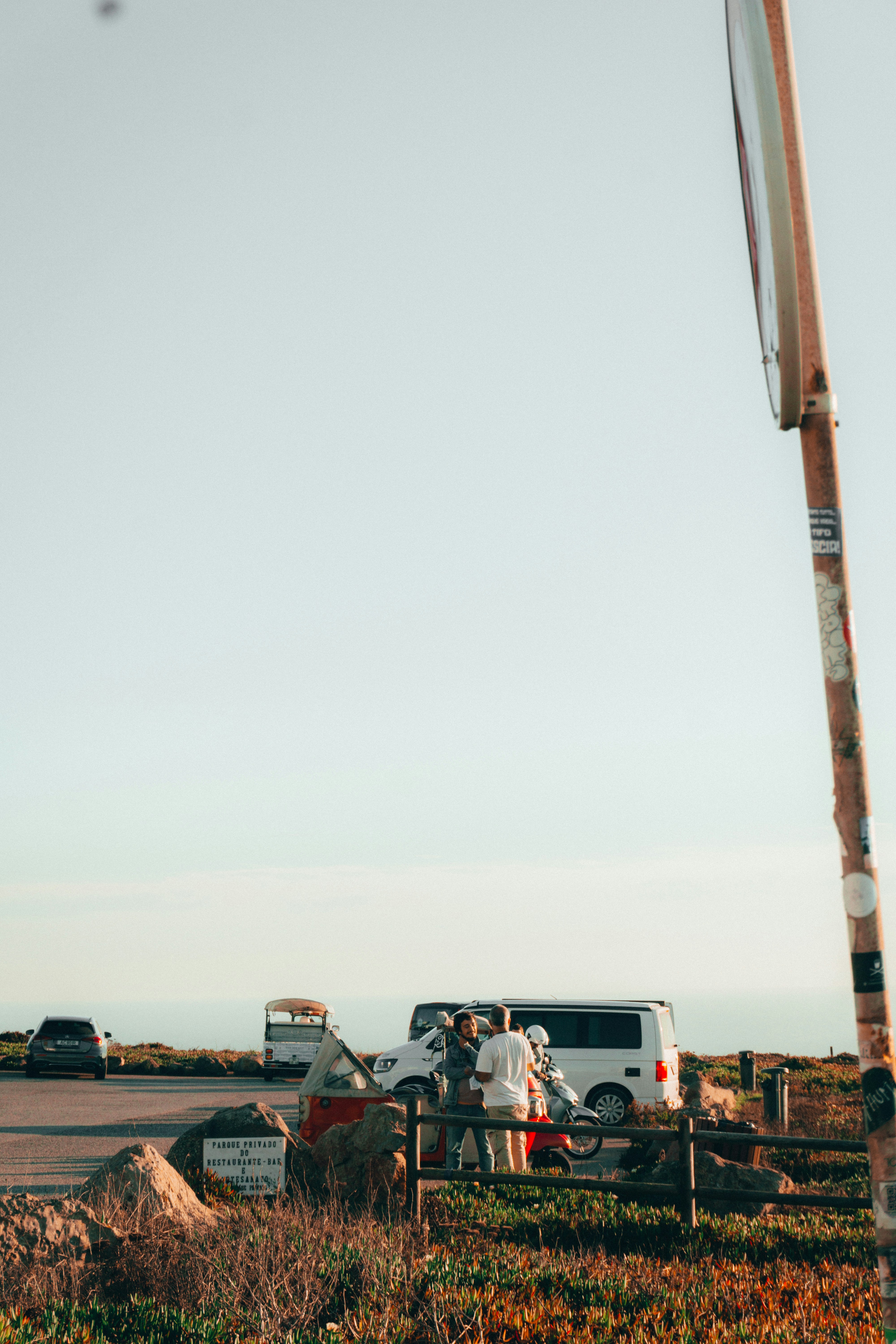 People talking in a parking lot near Cabo da Roca, Portugal.