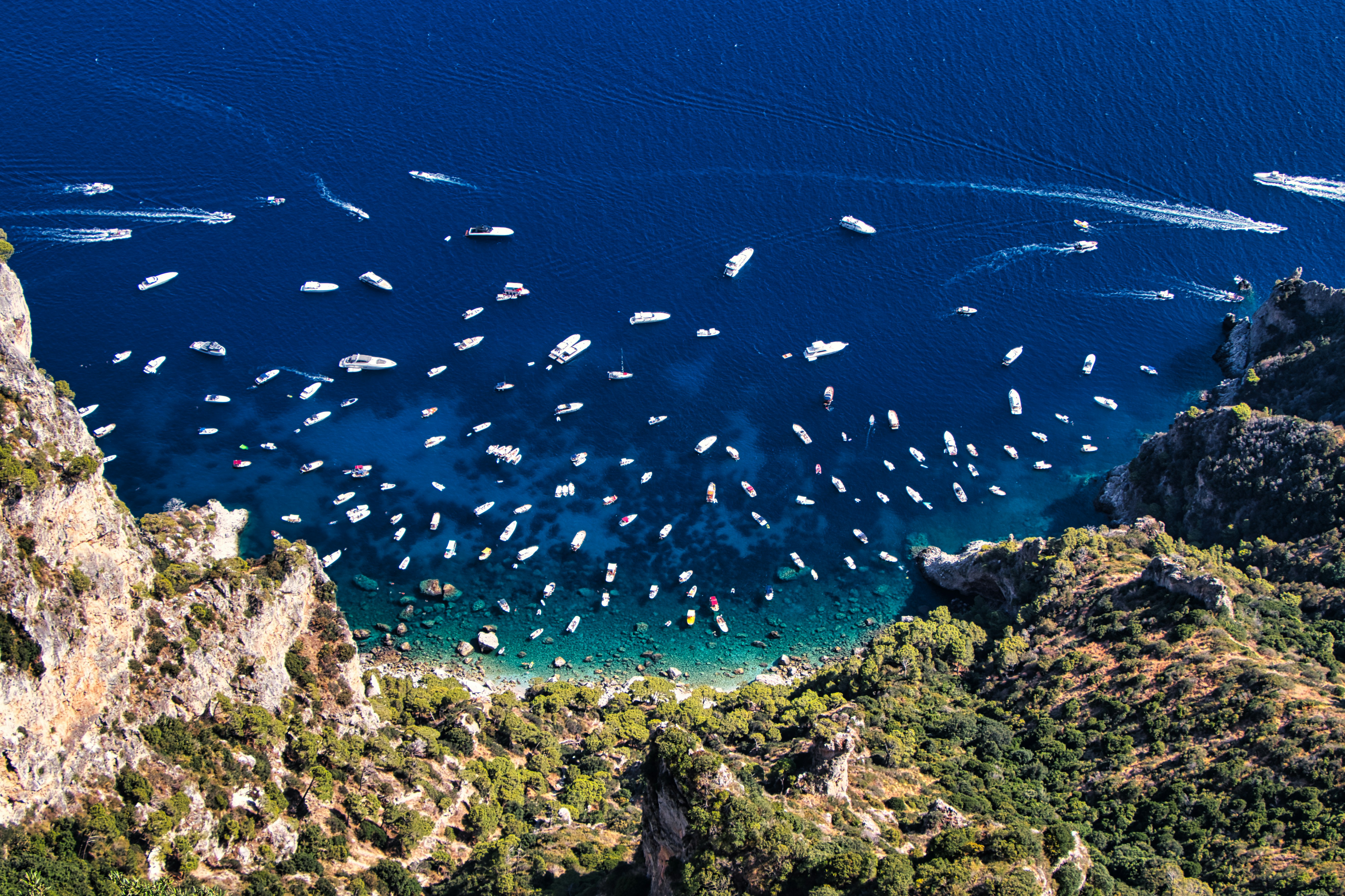 a group of boats floating on top of a body of water