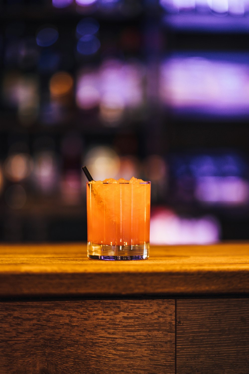 a drink sitting on top of a wooden table