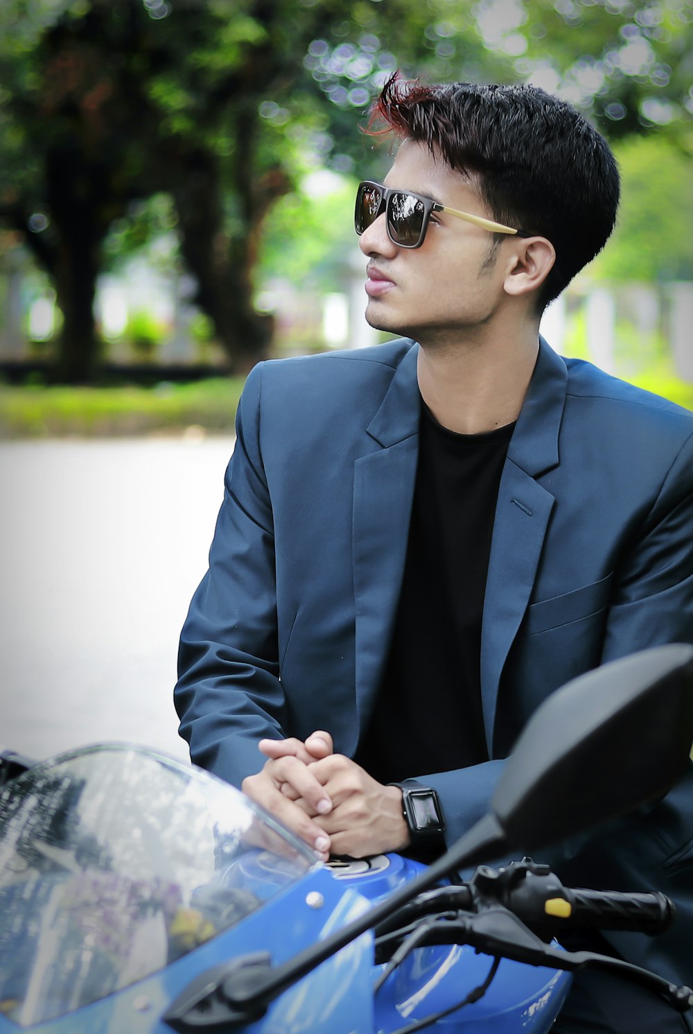 a man sitting on a motorcycle wearing sunglasses