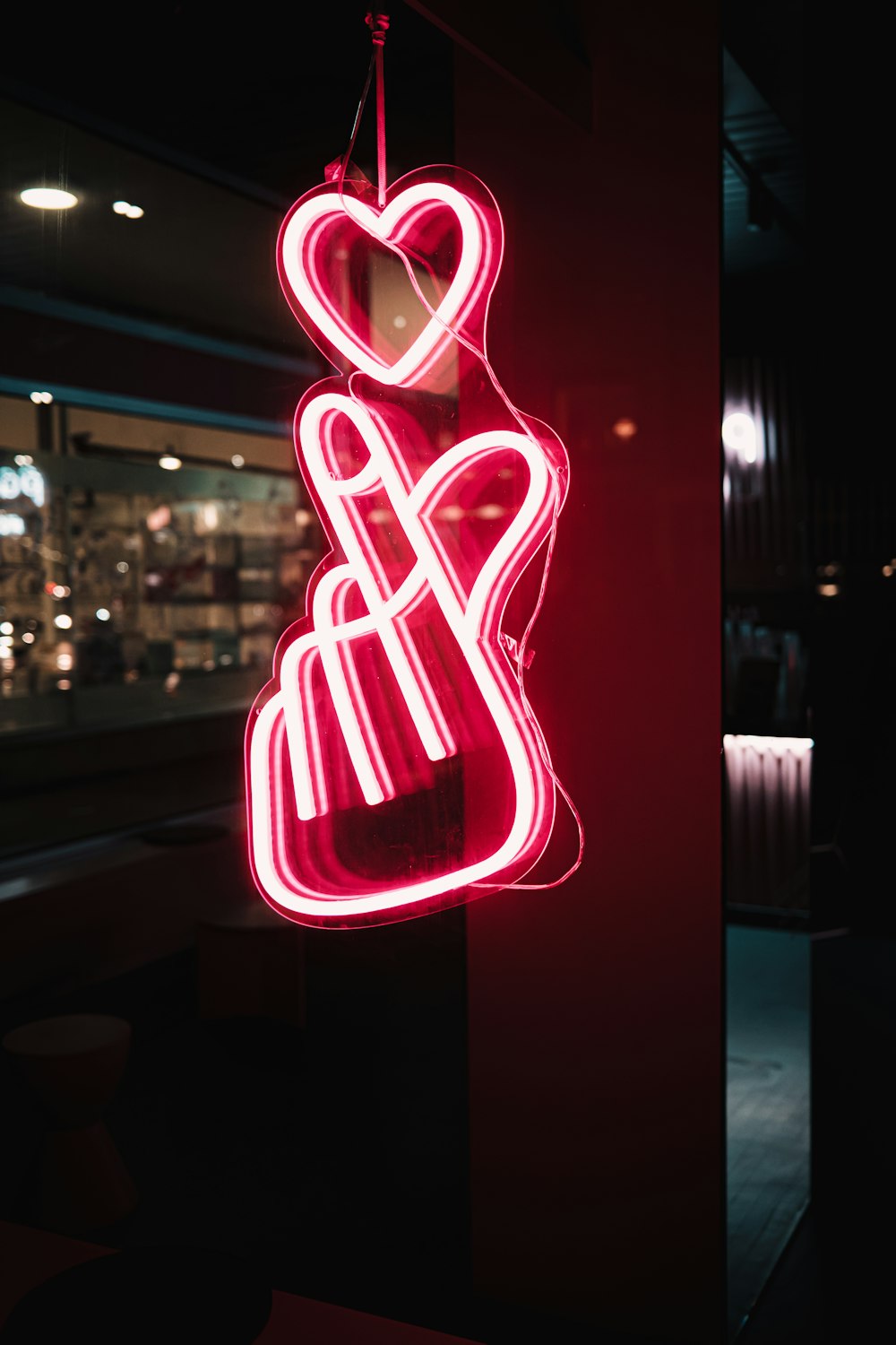 a neon sign hanging from the side of a building