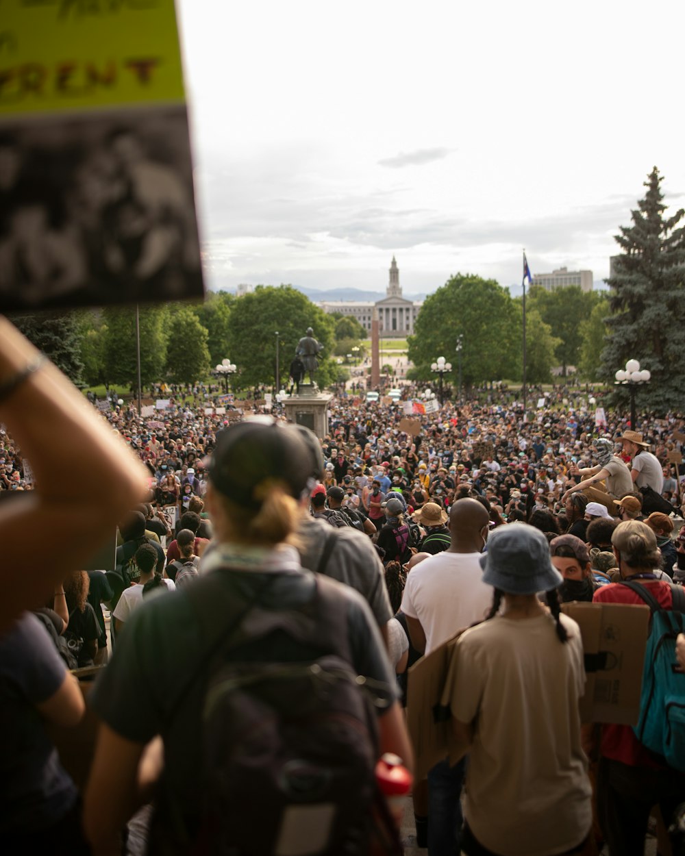 a large crowd of people standing in a park